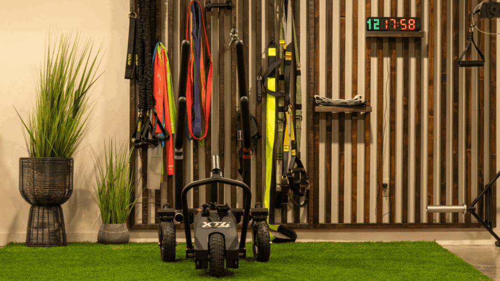 Vitruv private training studio with turf flooring and strength equipment designed for small group personal training in Waterbury, Vermont.